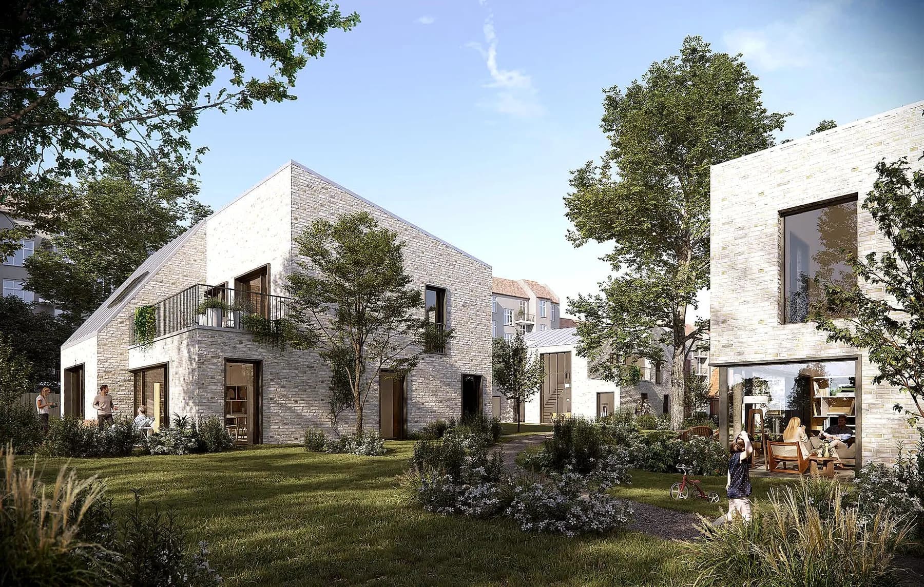 Lyse byhuse omkring en grøn have i Atelierhaven på Frederiksberg